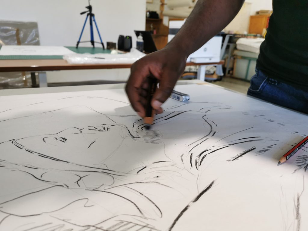 Mandla in the workshop drawing